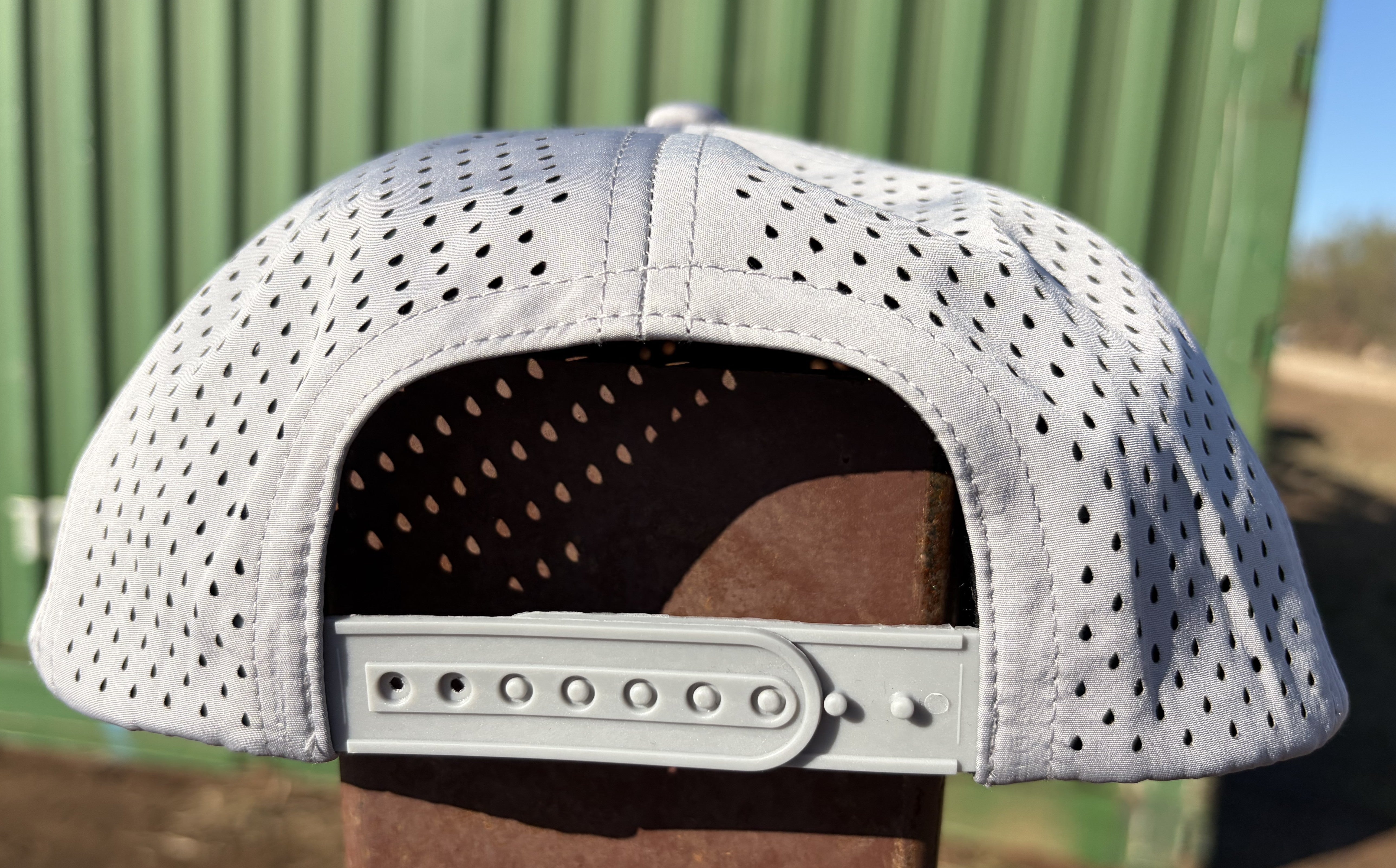 Back view of gray Hustlin Hippie hydro snapback hat with perforated breathable panels and adjustable snap closure