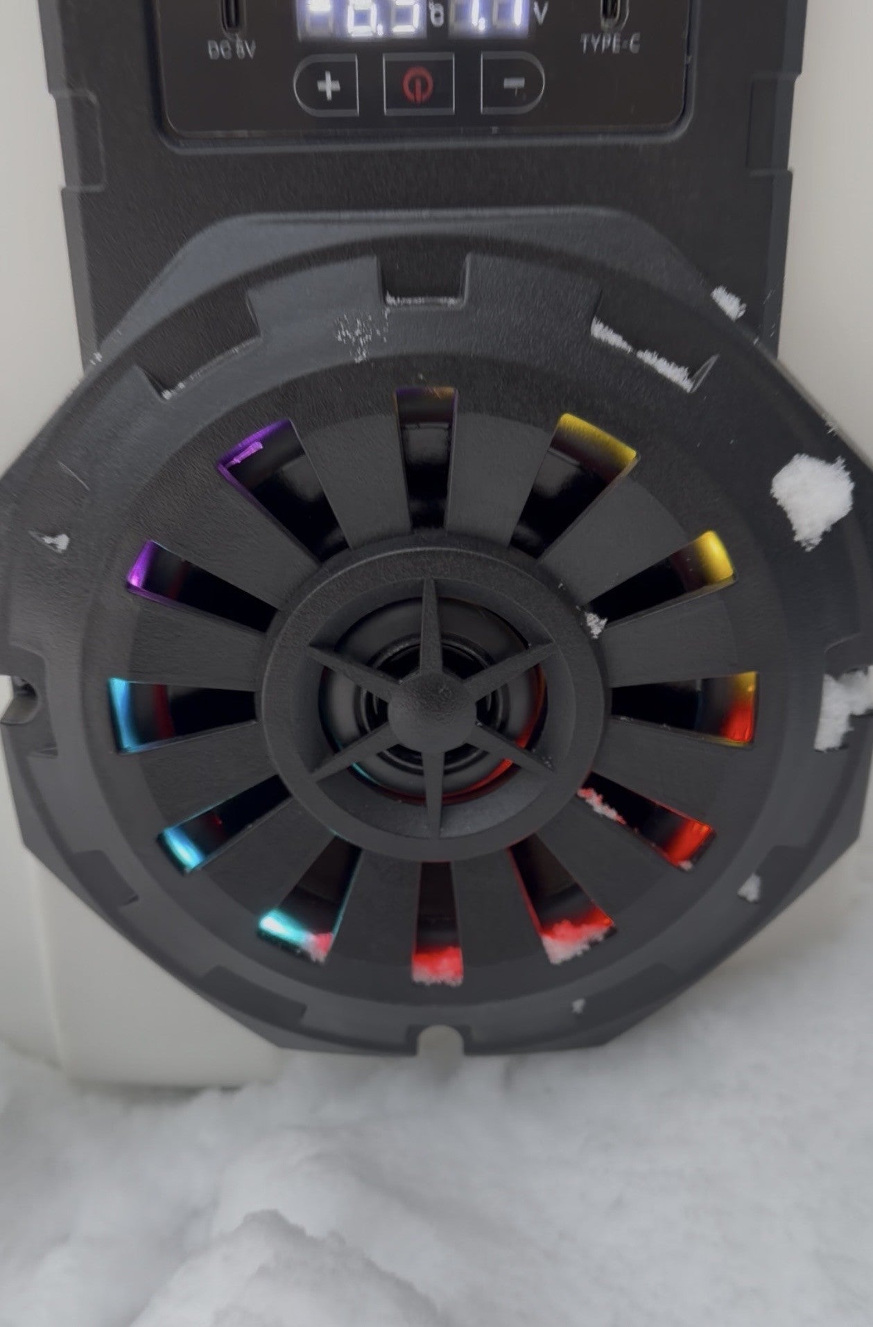 Close-up of Hound Boxx Bluetooth cooler speaker with RGB LED lights in the snow