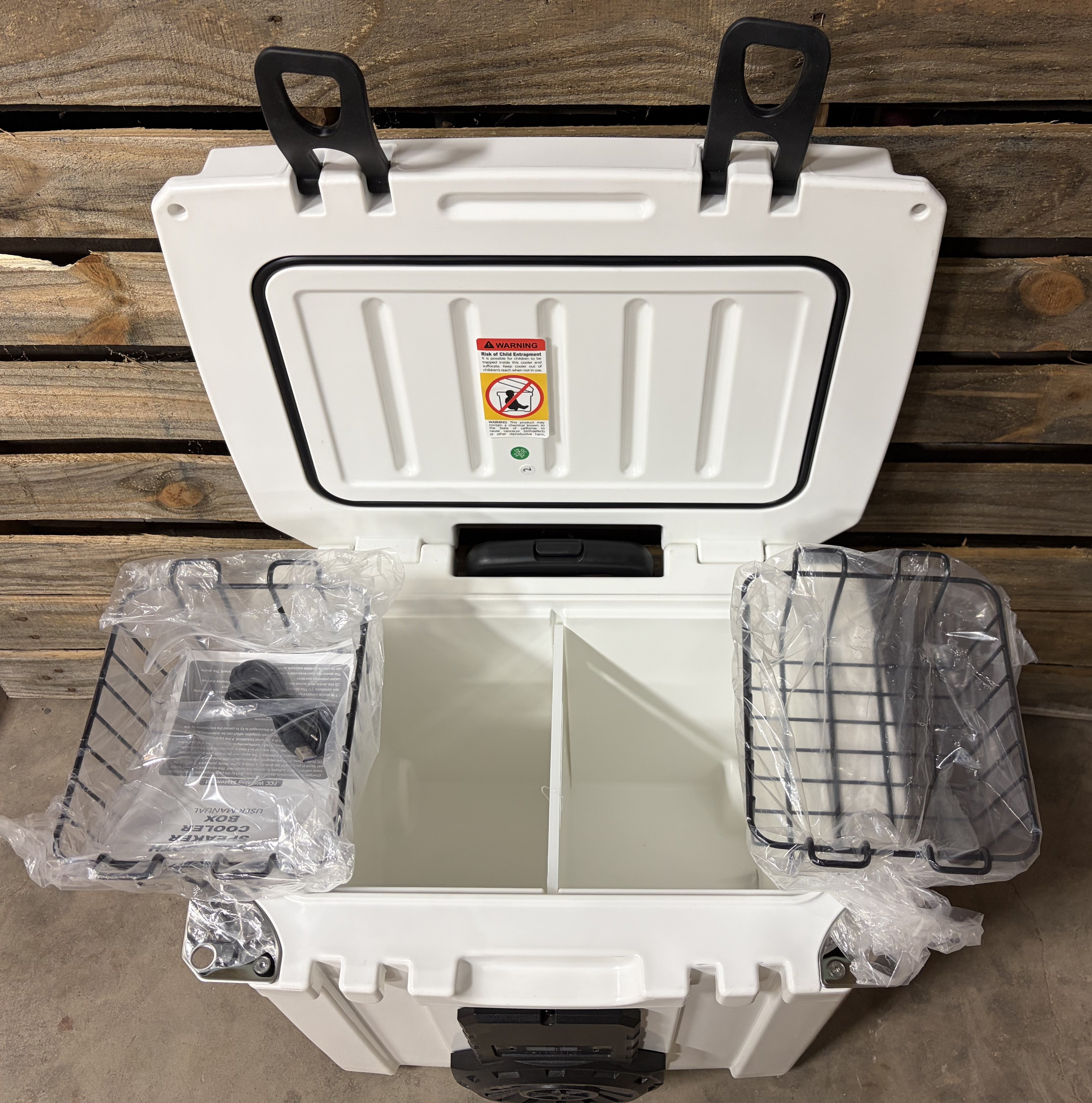 White Mono Hound Boxx speaker cooler showing divided interior storage compartments and removable wire baskets