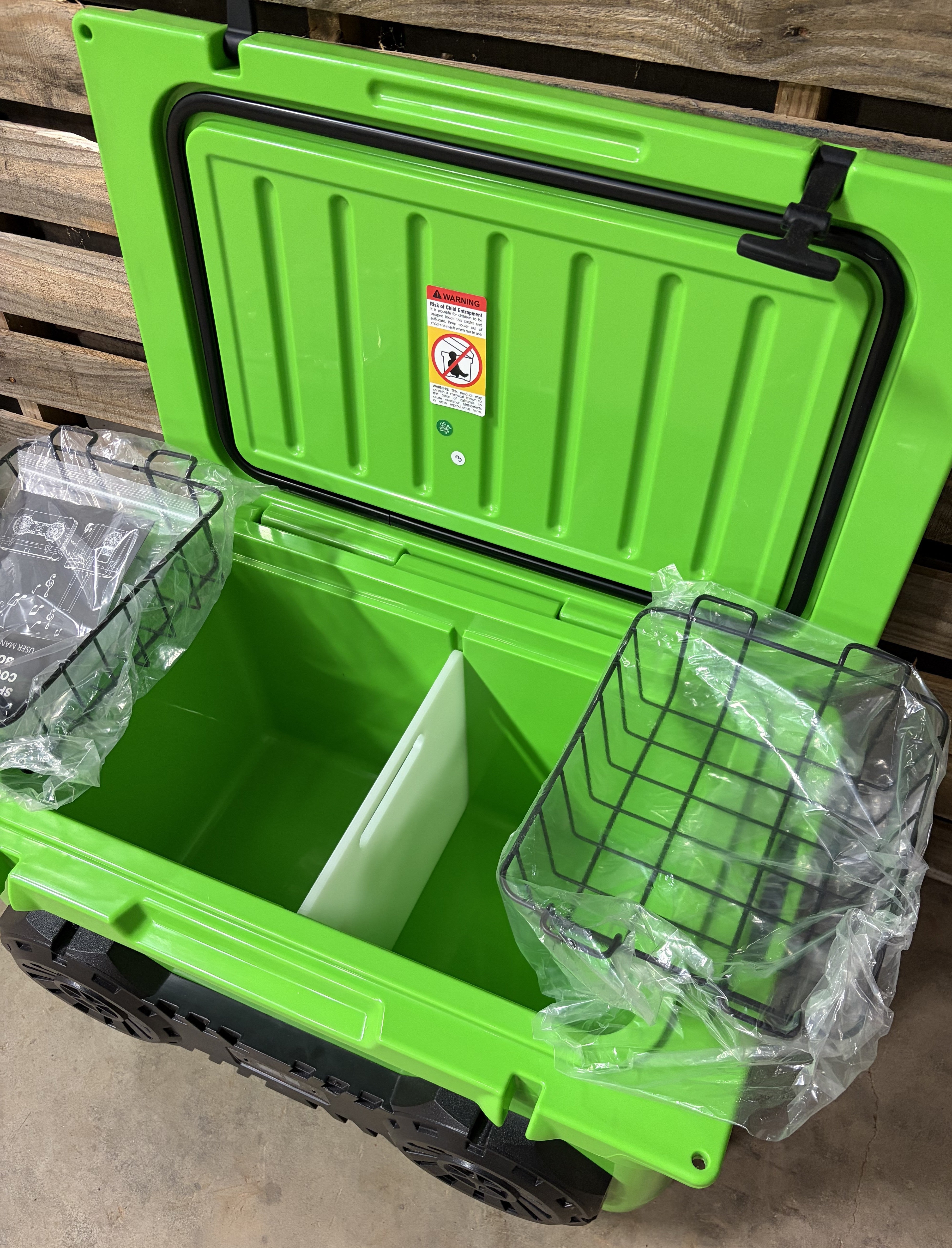 Neon Green Hound Boxx speaker cooler with built-in Bluetooth speakers and divided storage compartments, removable wire baskets, cutting board, and insulated interior design