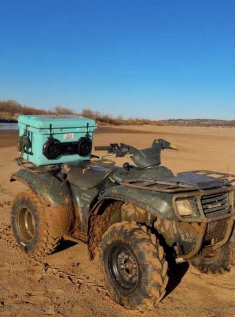 Hound Boxx cooler speaker mounted on ATV in sandy outdoor setting