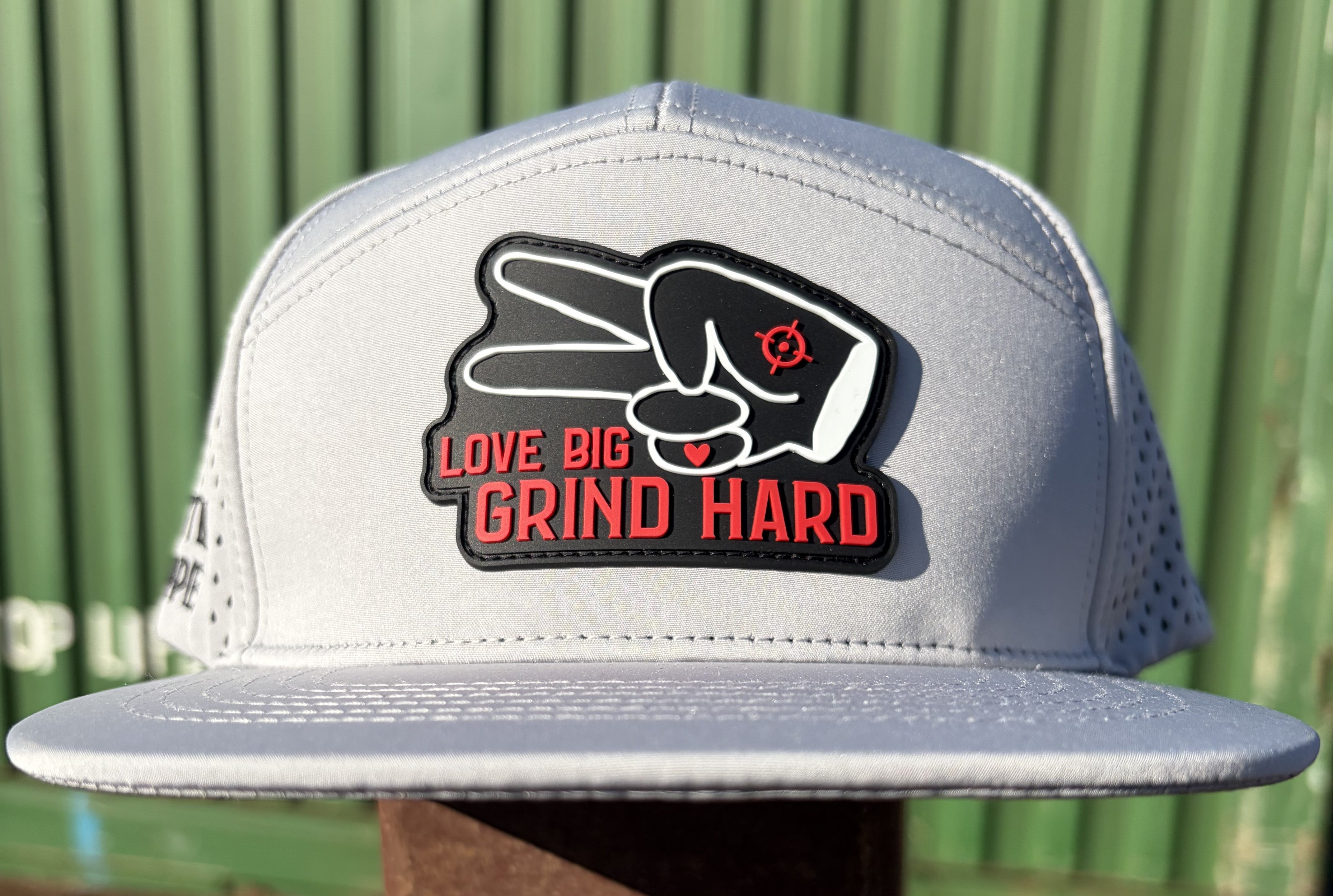 Front view of gray Hustlin Hippie Love Big Grind Hard performance snapback hat with flat bill