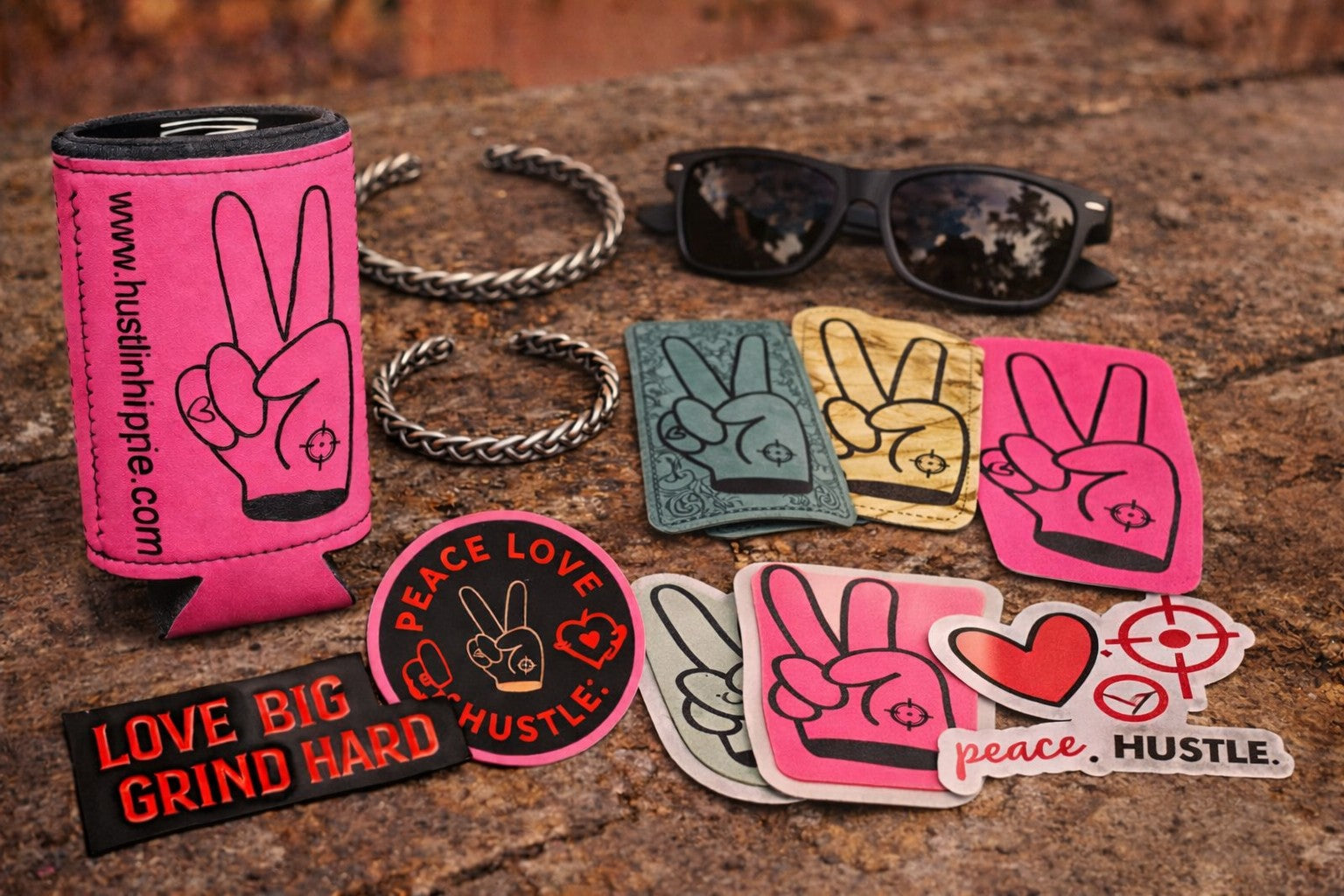 Hustlin Hippie accessories collection featuring koozies, hand-made metal bracelets, peace sign stickers, and trendy sunglasses.