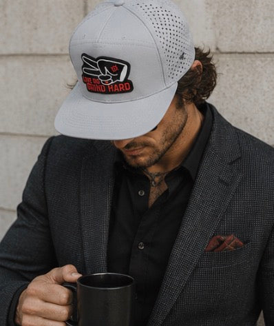 Gray Love Big Grind Hard hydro snapback hat styled with elevated smart casual blazer outfit