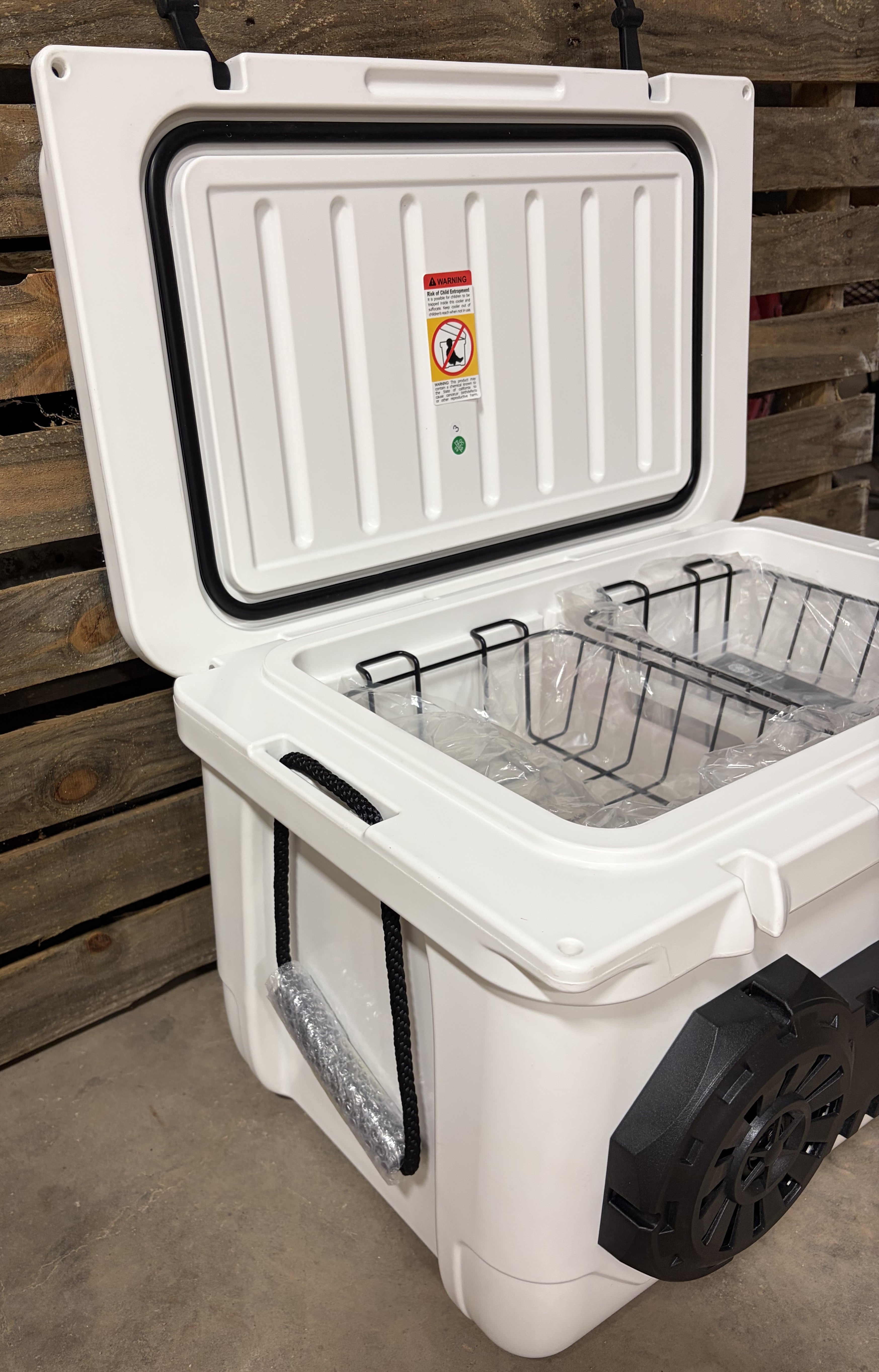 White Hound Boxx speaker cooler with insulated lid, removable storage baskets and built-in dual Bluetooth speakers