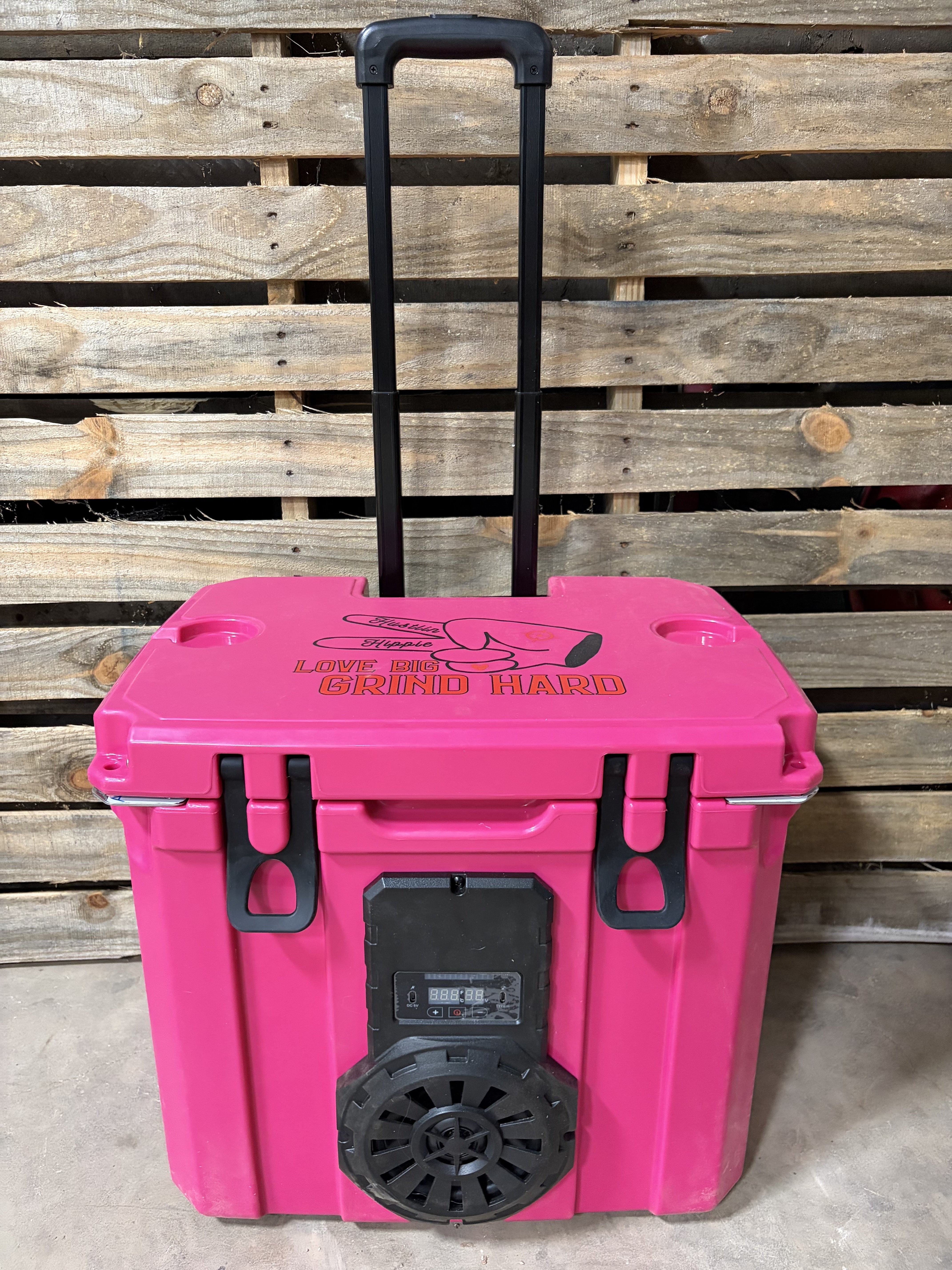 Pink mono Hound Boxx speaker cooler with rolling handle and rugged outdoor design