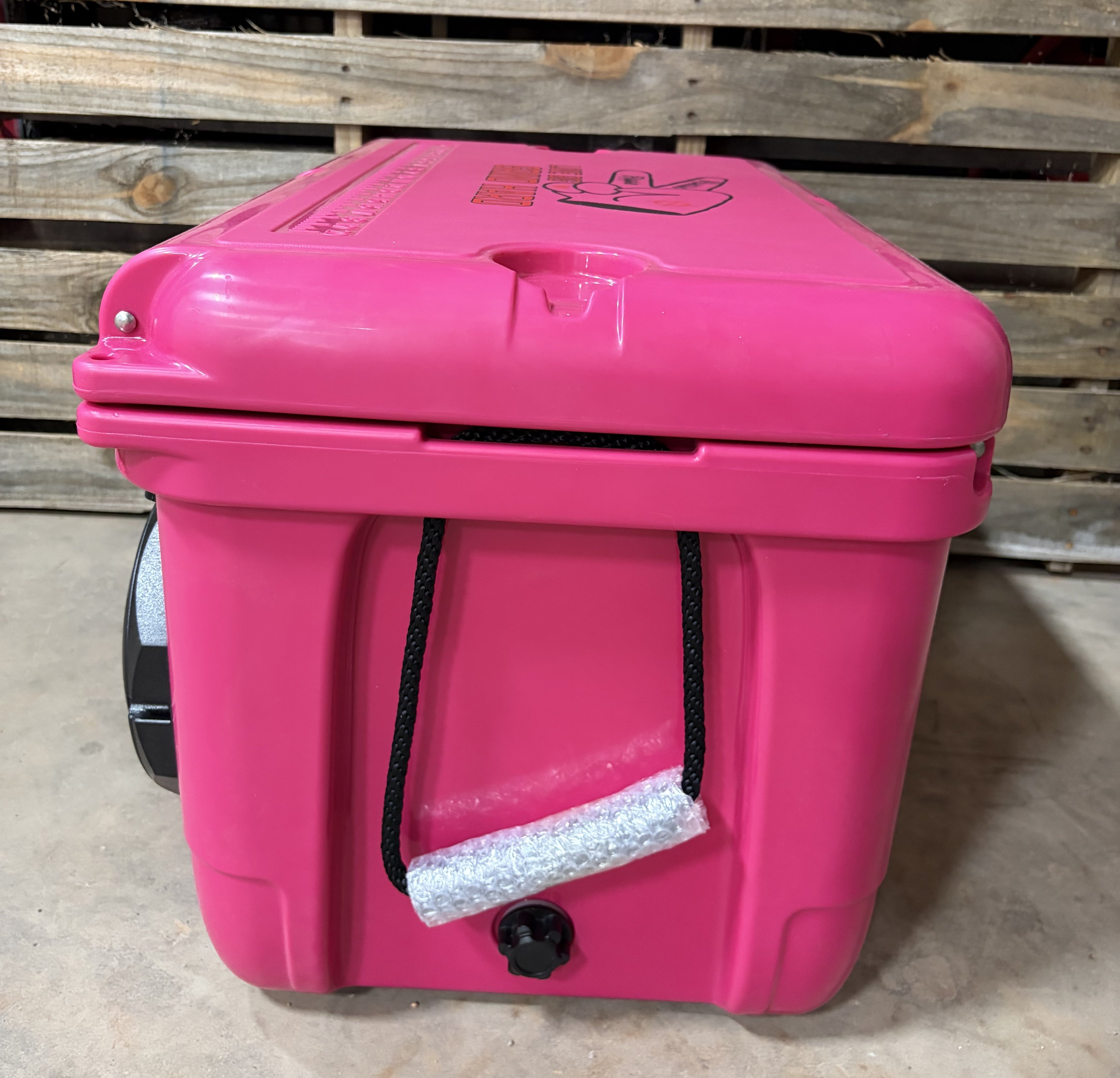 Rosy Pink Hound Boxx speaker cooler showing drain plug, rope carry handle and insulated hard-shell construction