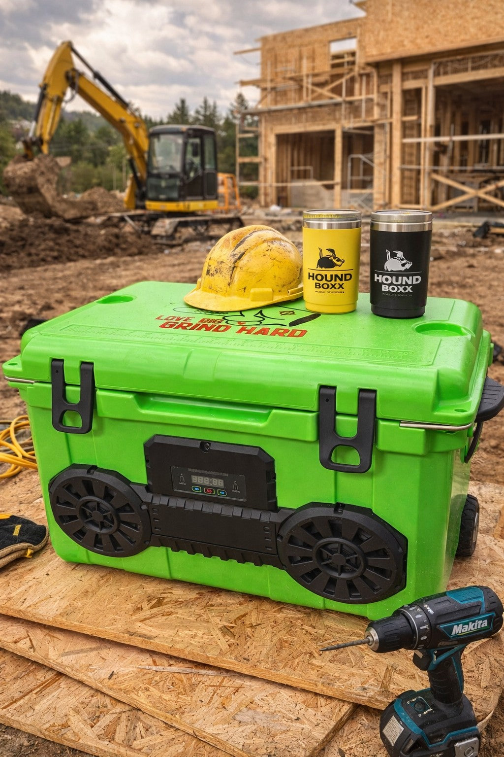 Neon Green Hound Boxx Bluetooth speaker cooler at construction jobsite with hard hat and tumblers