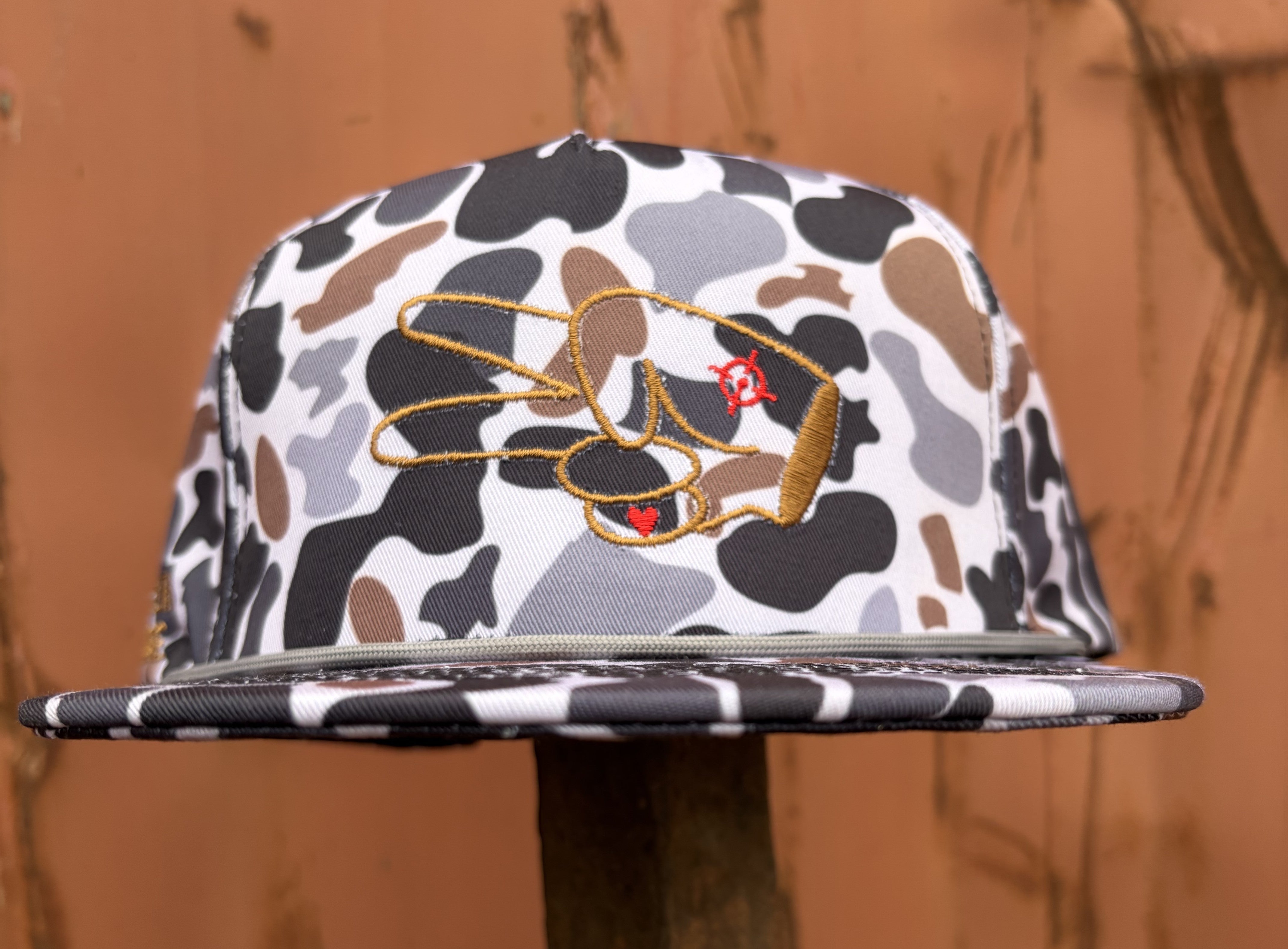 Close front shot of the Hustlin Hippie Signature Midnight Camo flat bill rope snapback hat featuring all-over camo print and embroidered signature logo.