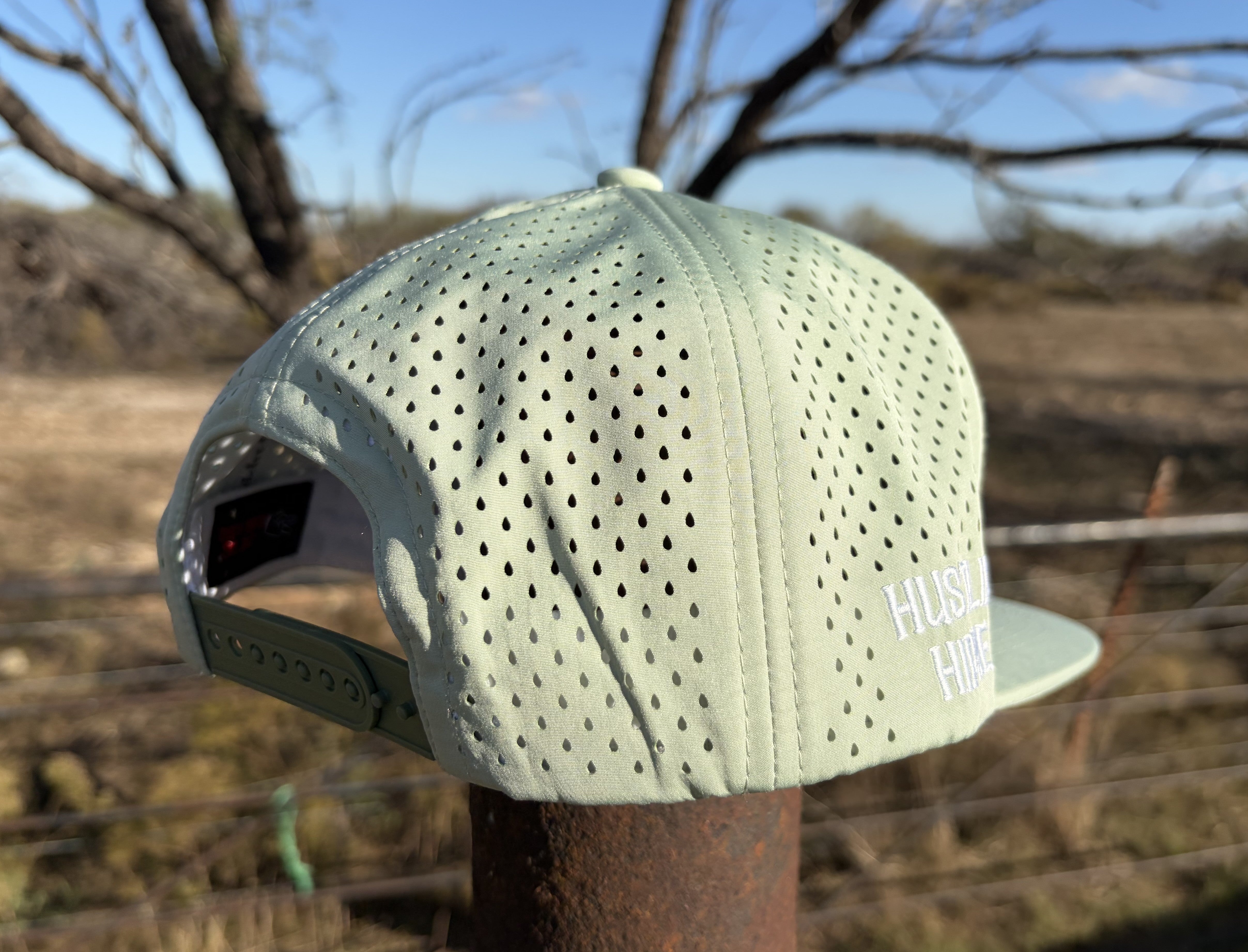 Back view of the Signature Mint Green Hydro Snapback Hat showing breathable laser perforations and adjustable snap closure.