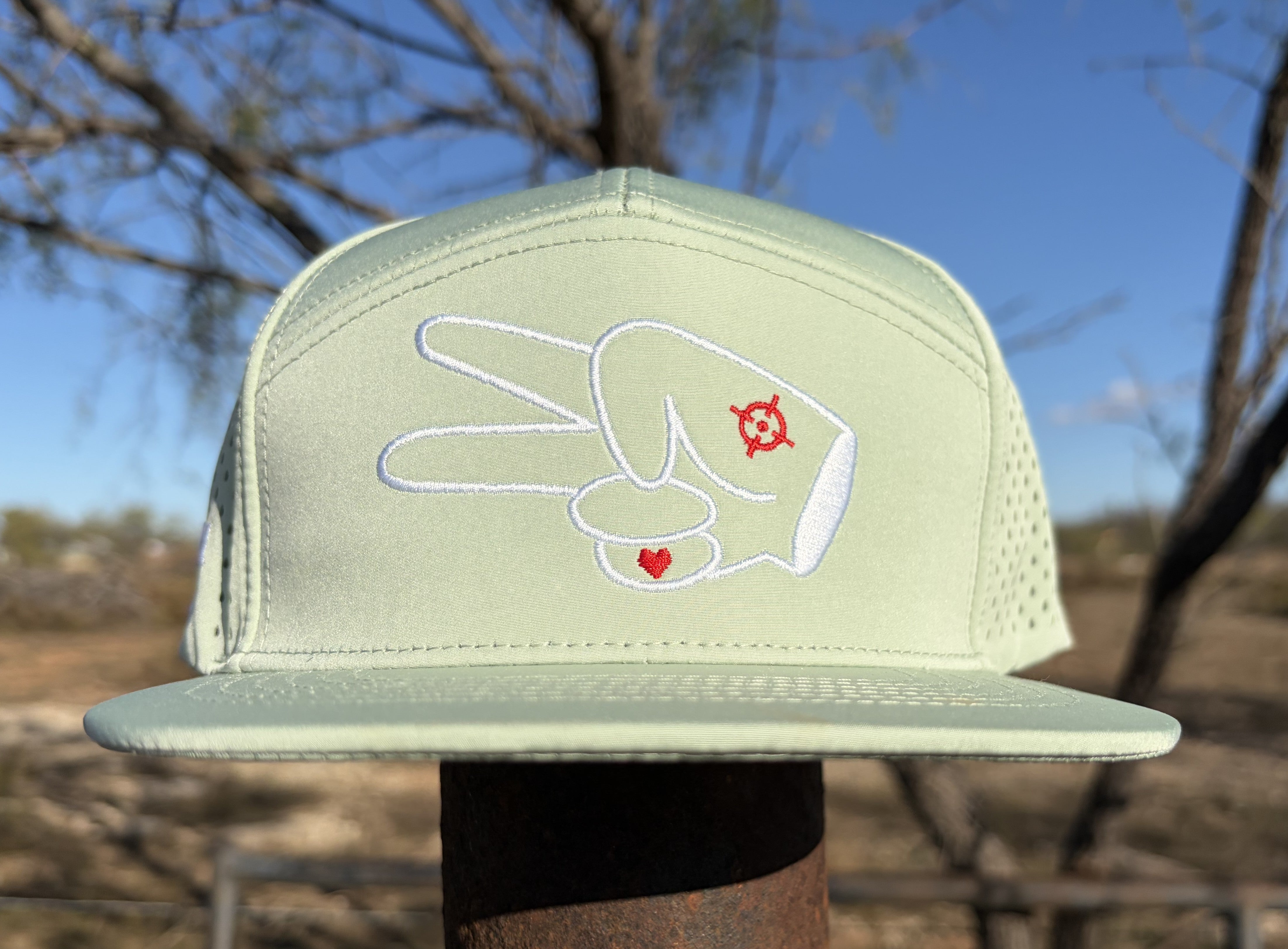 Front view of the Signature Mint Green Hydro Snapback Hat with embroidered peace sign hand logo and structured flat bill.