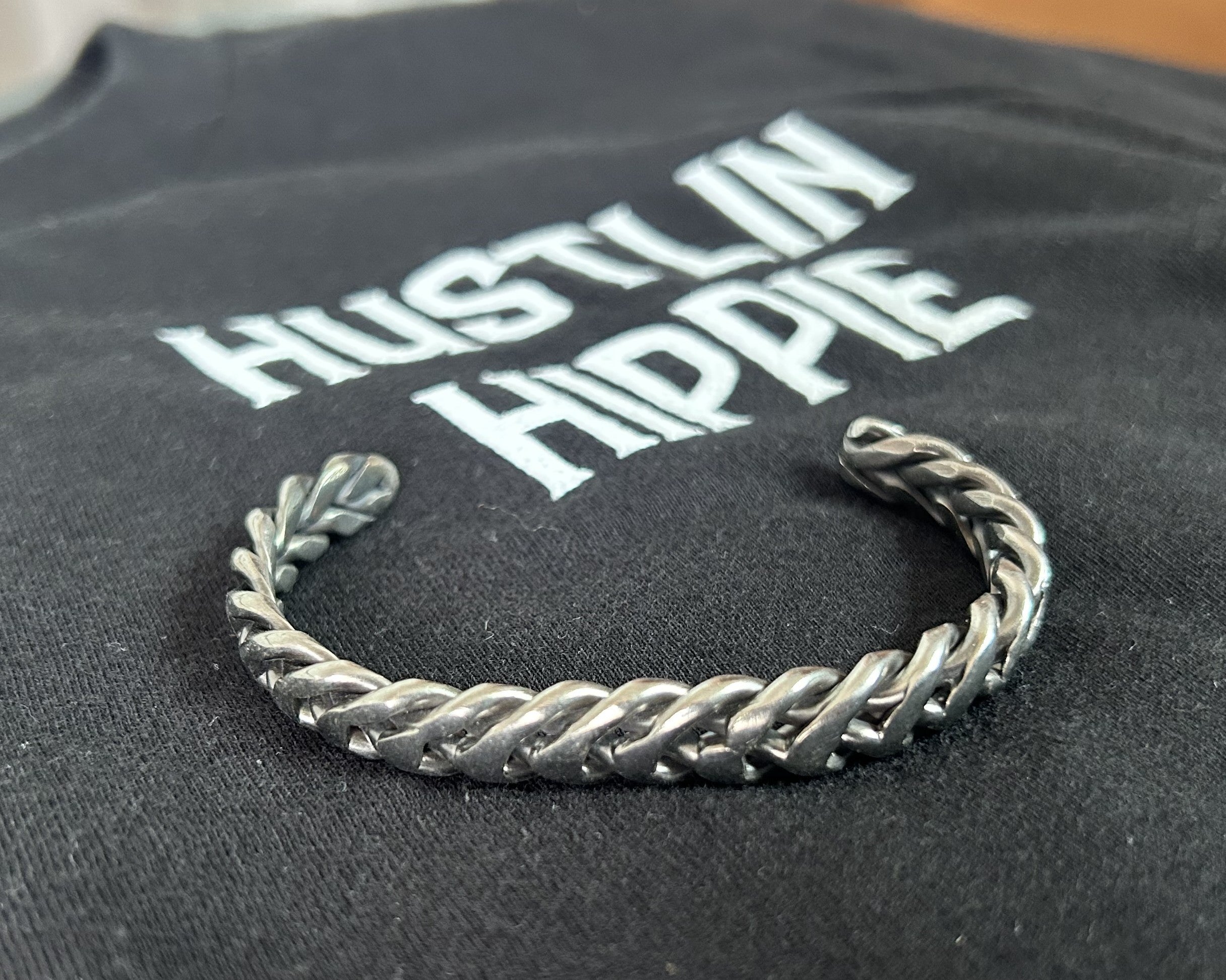 Closeup of braided handmade stainless steel cuff bracelet